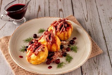 Swedish potato dumplings with cranberry sauce on a light background