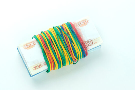 a bundle of money is tied with elastic bands, the concept of savings