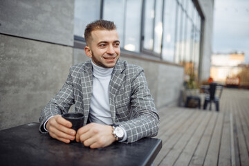 Photo portrait of laughing man in plaid suit drinking coffee looking at side