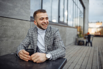 Photo portrait of laughing man in plaid suit drinking coffee looking at side