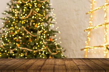 A table with a place for your advertisement. Christmas tree with lights. Home interior.
