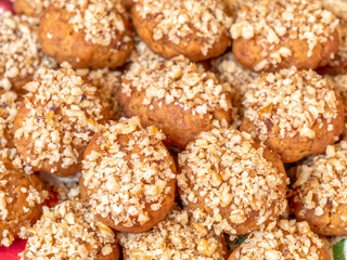 melomacarona, traditional Greek Christmas gourmet cookies with honey syrup and nuts, brown pattern background