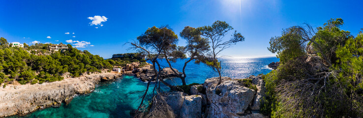 Spain, Mallorca, Santanyi, Helicopter view of bay surrounded by steep coastal cliffs in summer