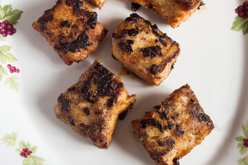 Overhead view of pieces of hake loin caramelized with paprika.