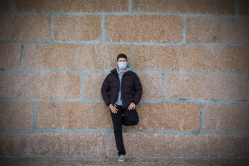 man with disposable surgical mask on his face for protection from viruses and infections