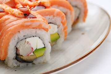 Philadelphia sushi roll served on plate on white table