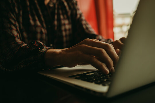Hands of businesswoman working on laptop in office - Powered by Adobe