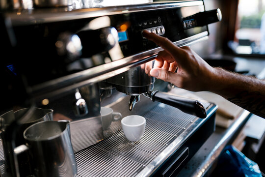 Male barista preparing coffee in cafe