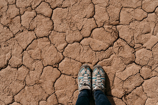 Spain, Navarre, Shoes of woman standing on dry cracked ground ofÔøΩBardenasÔøΩReales