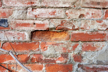 Red brick wall, dropped one brick