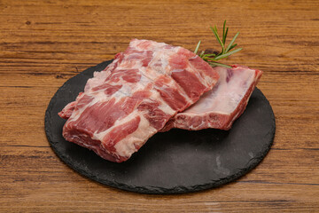 Raw pork ribs served rosemary