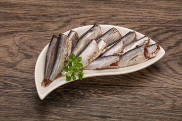 Anchovies in the bowl served basil leaves