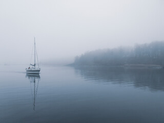 A small lost yacht sails alone through bad weather.