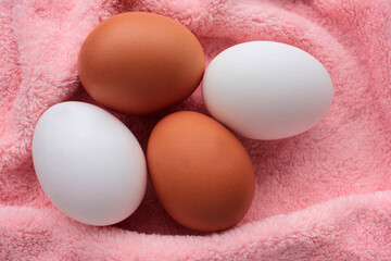 Fresh chicken eggs on pink background. View from overhead. 