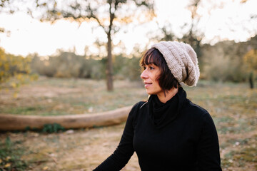 Woman practicing yoga and meditating on the park bench