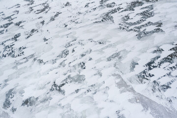 Arctic tundra landscape in northern Canada on the shores of Hudson Bay from the town of Churchill, Manitoba. Taken from a helicopter with aerial, above view of the frozen landscape. 