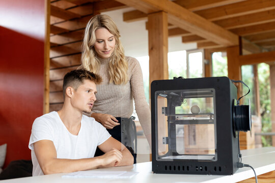 Team Examining 3D Printer At Home