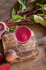 A glass of beetroot juice with fresh red beets