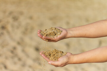 Girl’s hands playing with sand with clear background
