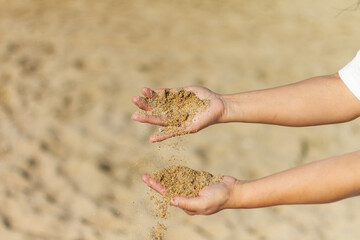 Girl’s hands playing with sand with clear background