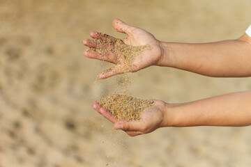 Girl’s hands playing with sand with clear background