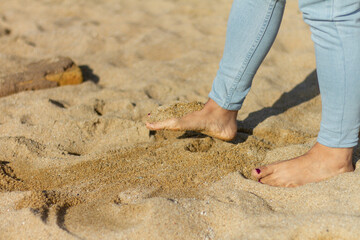 Girl peep playing with sand with painted nails