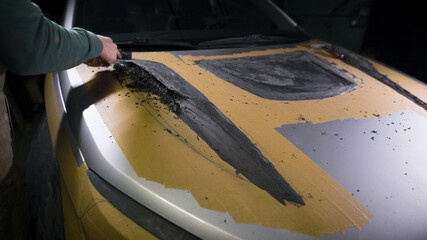 A master with loops in his hands displays the shape of a part. A man works on a mock-up of a sports...