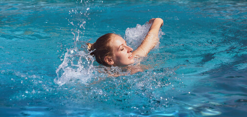 Beautiful young nude woman in swimming pool