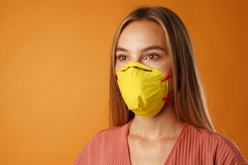 Young beautiful casual woman wearing protective medical mask of Illuminating Yellow Color