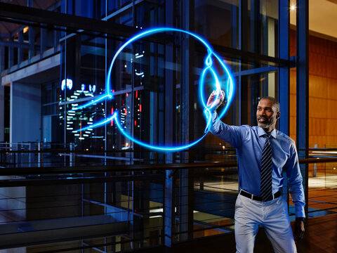 Male ophthalmologist light painting eyeball in laboratory at hospital