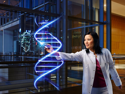 Mature female doctor light painting DNA in laboratory at hospital
