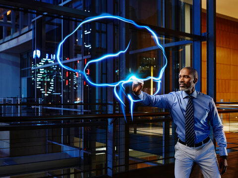 Male specialist light painting brain in laboratory at hospital