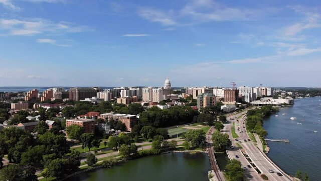 Drone Aerial View of Madison, Wisconsin USA. Cityscape, Downtown in Skyline and Traffic on Freeway by Monona Lake on Sunny Summer Day