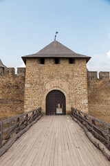 Fototapeta na wymiar Passage to the medieval castle, the main gate, the wooden bridge, the only door. Ancient fort.