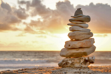 A composition of stacked stones on the beach. Focus on the right.