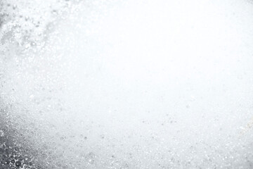 Grey-colored foam shot in macro style. There is light space for your text. Black and white photo...