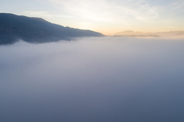Flying through the clouds at dawn above the jumping lake in Rieti