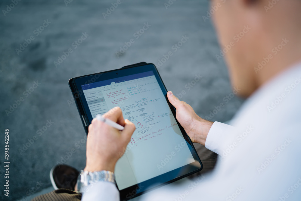 Poster cropped image of professional entrepreneur creating graphic design via application on touch pad usin