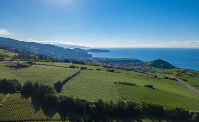 Aerial view landscape over the North Cost of the Island of São Miguel, with the green fields and the blue ocean as background. Azores, Portugal.