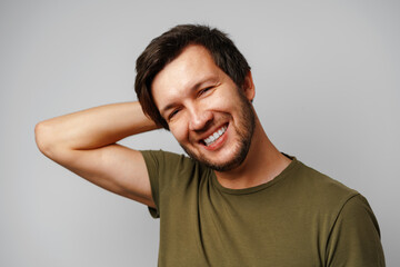 Handsome young man portrait smiling against grey background