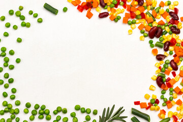 Green peas, beans and carrots, corn and rosemary on white