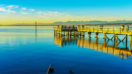 Sunday afternoon fishing at Crescent Beach Pier as evening approaches - winter
