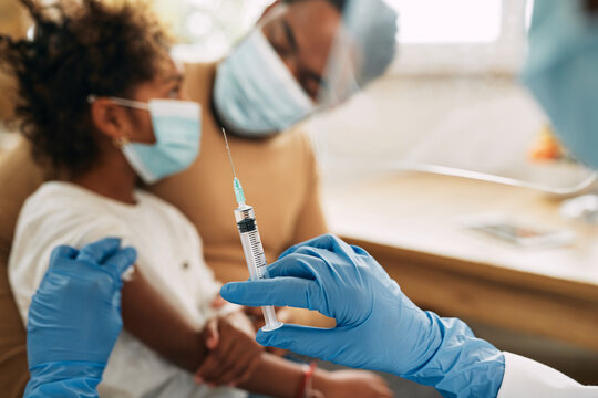 Close-up Of Doctor Giving Vaccine To A Child At Medical Clinic.