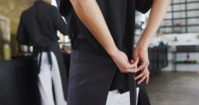 Caucasian Male Chef Tying Cooking Apron