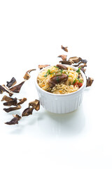 cooked rice with dried forest mushrooms isolated on white