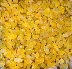 Golden raisins from white grapes of bright yellow color. Fruits nuts vegetables berries useful products agriculture.