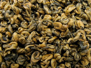 The leaves of red tea Dian Hong van. Dianhong tea. Chinese red tea Golden Curls (Dianhong Jin Luo). Red furry tea buds.