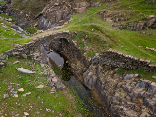 Ancient bridge over a stream near the Alagon River. Extremadura. Spain.