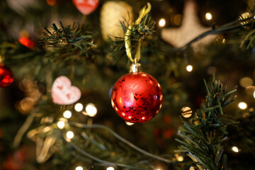 Shallow depth of field (selective focus) image with a red ornament in a plastic Christmas tree.