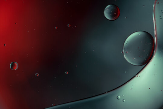 Falling drops of liquid metal, drops hovering in the air. Abstract effect of flowing fluid.